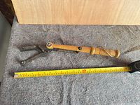Full view of skeet thrower beside tape measure showing 0-70 cm (approx 30 in.) length