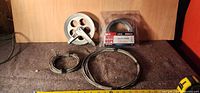 HaulMaster packaged wire rope, two loose coils, pulley laid out with tape measure