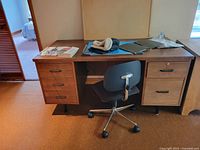Desk with five drawers and accompanying swivel chair