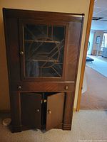 Front view showing full bookcase with glass door, drawer, and lower cabinet