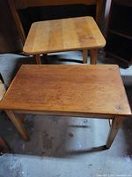 Two wooden tables, square and rectangular tops