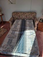 Loveseat with pull-out bed extended showing mattress