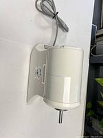 Side view of Champion juicer motor with mounting bracket and shaft