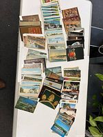 Overhead view of multiple stacks of postcards spread on table