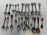 All 24 souvenir spoons laid out