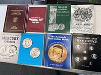 Group shot of all eight coin reference books laid out on table