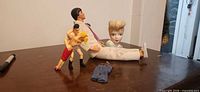 Overall lot showing fashion doll, porcelain head vase, two small action figures, doll jeans, marker pen