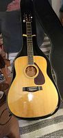 Full view of Yamaha FG-340 acoustic guitar inside hard shell case