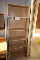 Front view of full-height bookcase showing five shelves