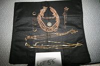 Full lot overview on black background showing rings, pendant and chains