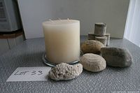 Group view of candle on plate, stones, corals and concrete cores