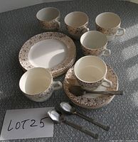 Group view of all cups, plates, saucers and teaspoons