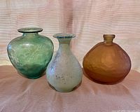 Three frosted glass bottles front view