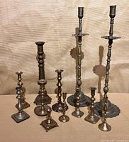 Group shot of all twelve brass candlesticks