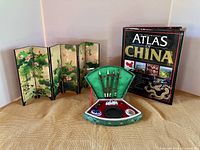 Overview of all three items: folding screen, open calligraphy set in silk box, Atlas of China book