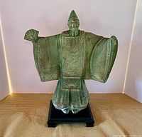 Full view of verdigris plaster Ji Gong statue on black base