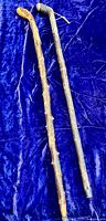 Two blackthorn walking sticks on blue fabric