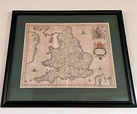 Full view of framed lithograph map in black frame with green mat