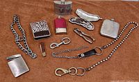 All items laid out showing variety including flasks, tools, case, chains