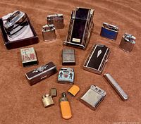 Group shot of all lighters and accessories on brown background