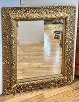 Full view of mirror showing entire gilded frame and glass
