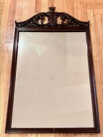 Full view of mahogany framed mirror on floor