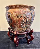 Fishbowl on rosewood stand, front figural panel visible