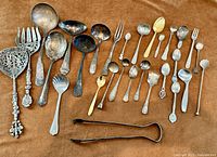Full lot showing all flatware pieces on brown background