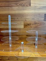 Both acrylic tier stands assembled with plates showing transparency and modular rods