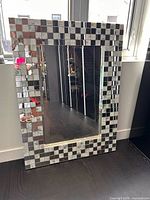 Front view showing full mirror and mosaic frame