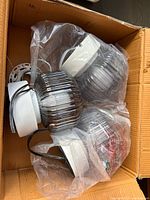 Three ribbed glass pendant shades with white canopies inside box