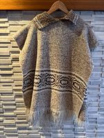 Front view of knit poncho hanging