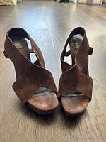 Front view of sandals showing criss-cross straps and open toe