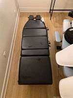 Top view showing full length of black vinyl cushioned table surface