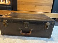 Front view showing brass latches, center lock and carry handle