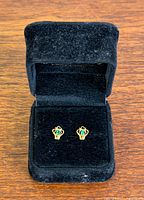 Pair of gold and emerald crown stud earrings in box, front view