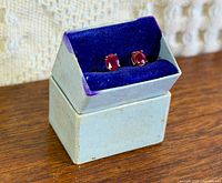 Earrings in presentation box, side angle view