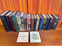 Front view of all books standing upright plus two laying flat