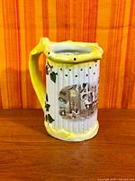 Front view showing tavern scene and yellow rim