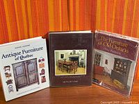 Front covers of the three antique furniture reference books