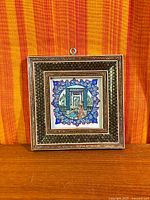 Full view of framed mosaic artwork front