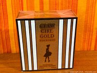 Front of sealed perfume box showing name and design