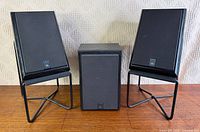 Front view of three JBL 2500 speakers, two on stands