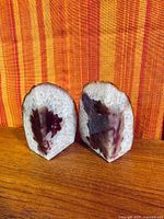 Front view of both agate geode bookends showing polished faces and crystalline texture