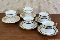 Group shot of all five cup and saucer sets on tabletop