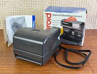 Camera, box, papers grouped