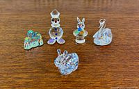 Five crystal figurines grouped on tabletop