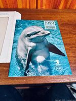 Front cover featuring dolphin image labeled 1990 Mint Set of Stamps