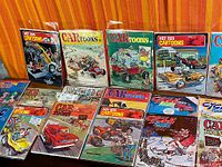 Thirteen bagged magazines laid out in two rows