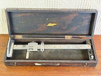 Height gauge in open wooden case, full view